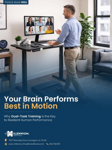 A photo of a man in a virtual meeting while also simultaneously walking on a walking pad at work.